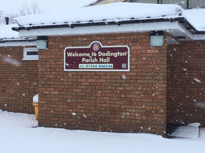 Dodington Parish Hall sign in the snow.