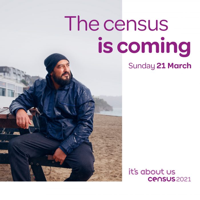 Promotional poster for Census 2021 with image of a man sat on a bench by the coast. Text says: "The Census is coming Sunday 21 March"