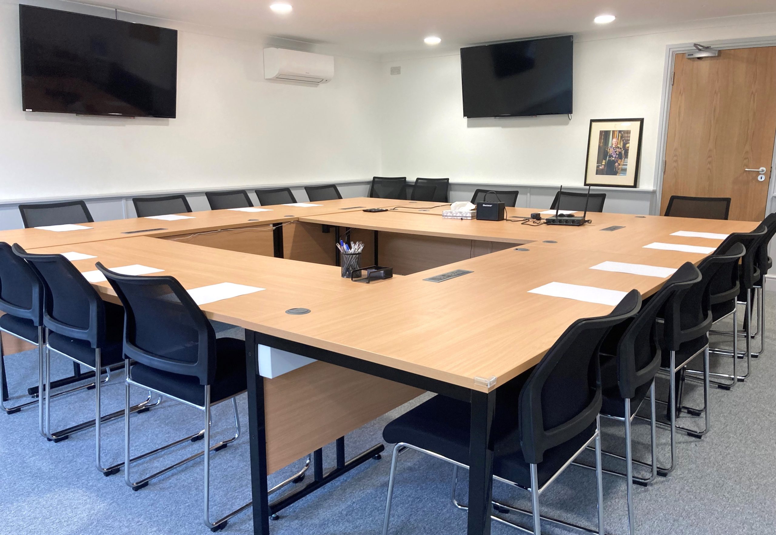 A photo of Dodington Parish Council Chamber,  There is a large table with chairs around it.